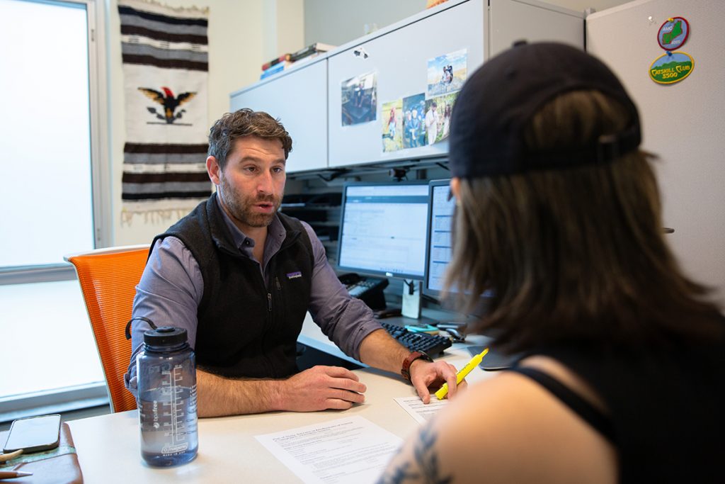 Matt Donofrio meets with student in his advising office.