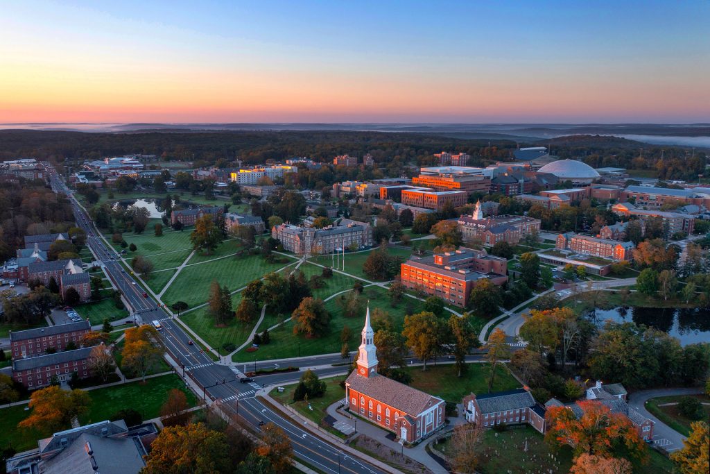 Aerial view of the UConn Storrs campus at sunset in fall, looking south toward the Austin Building.
